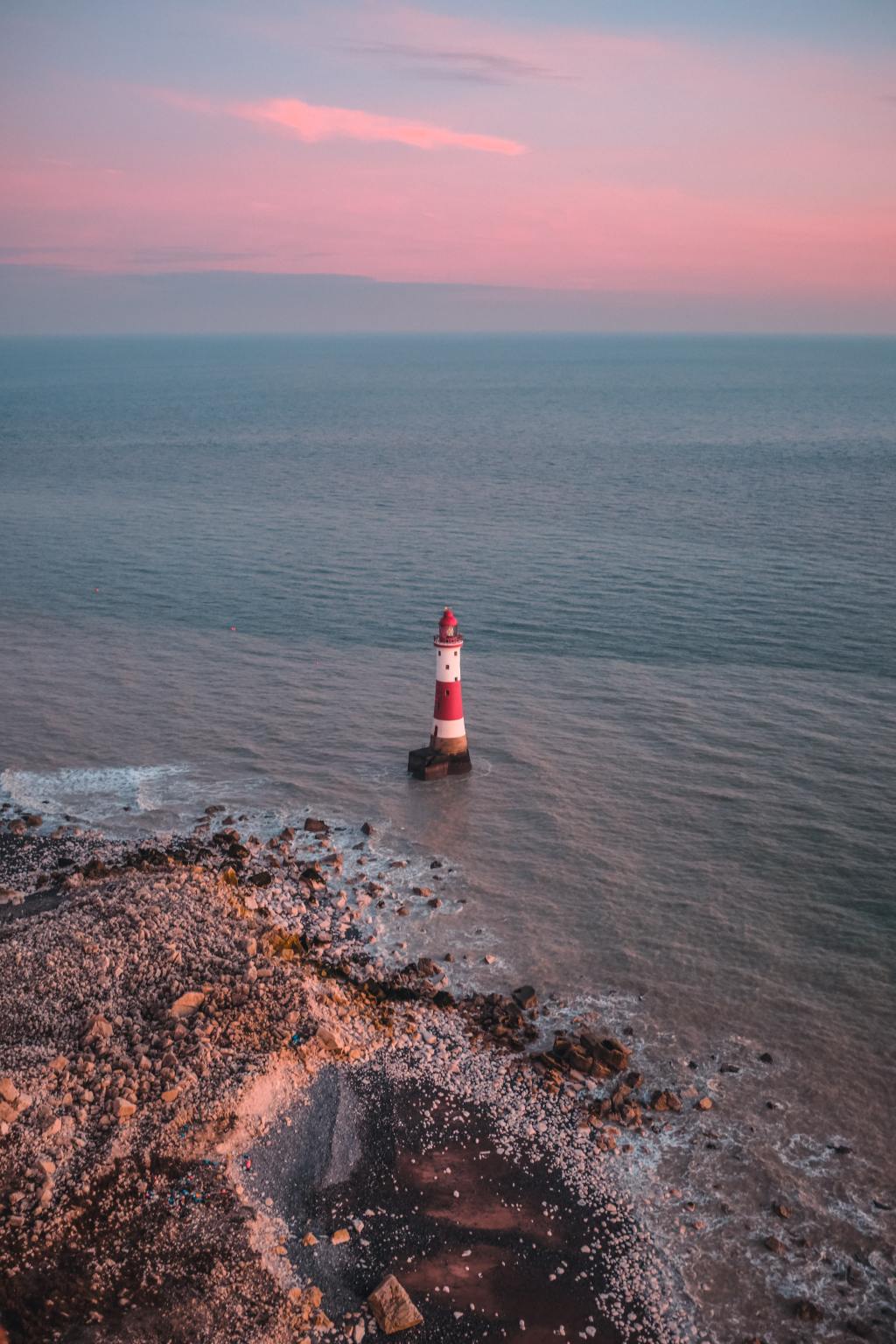 Eastbourne's Beachy Head lighthouse, sun rising in the east